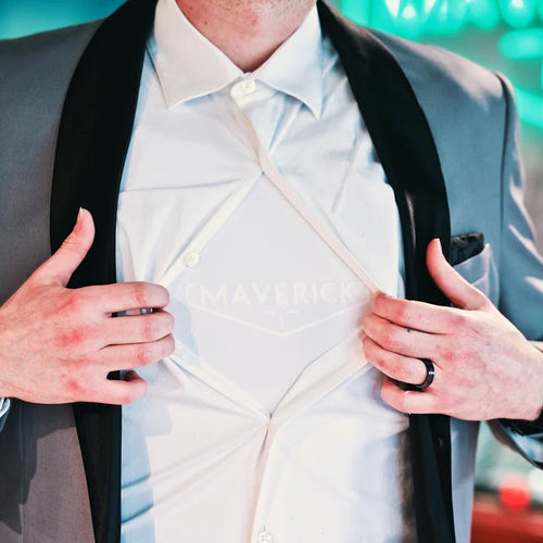*NEW 2026* HG2 Concealable Armor Shirt - Meridian EDC | Laserworks - Person wearing a white shirt with black suspenders over a gray suit jacket.