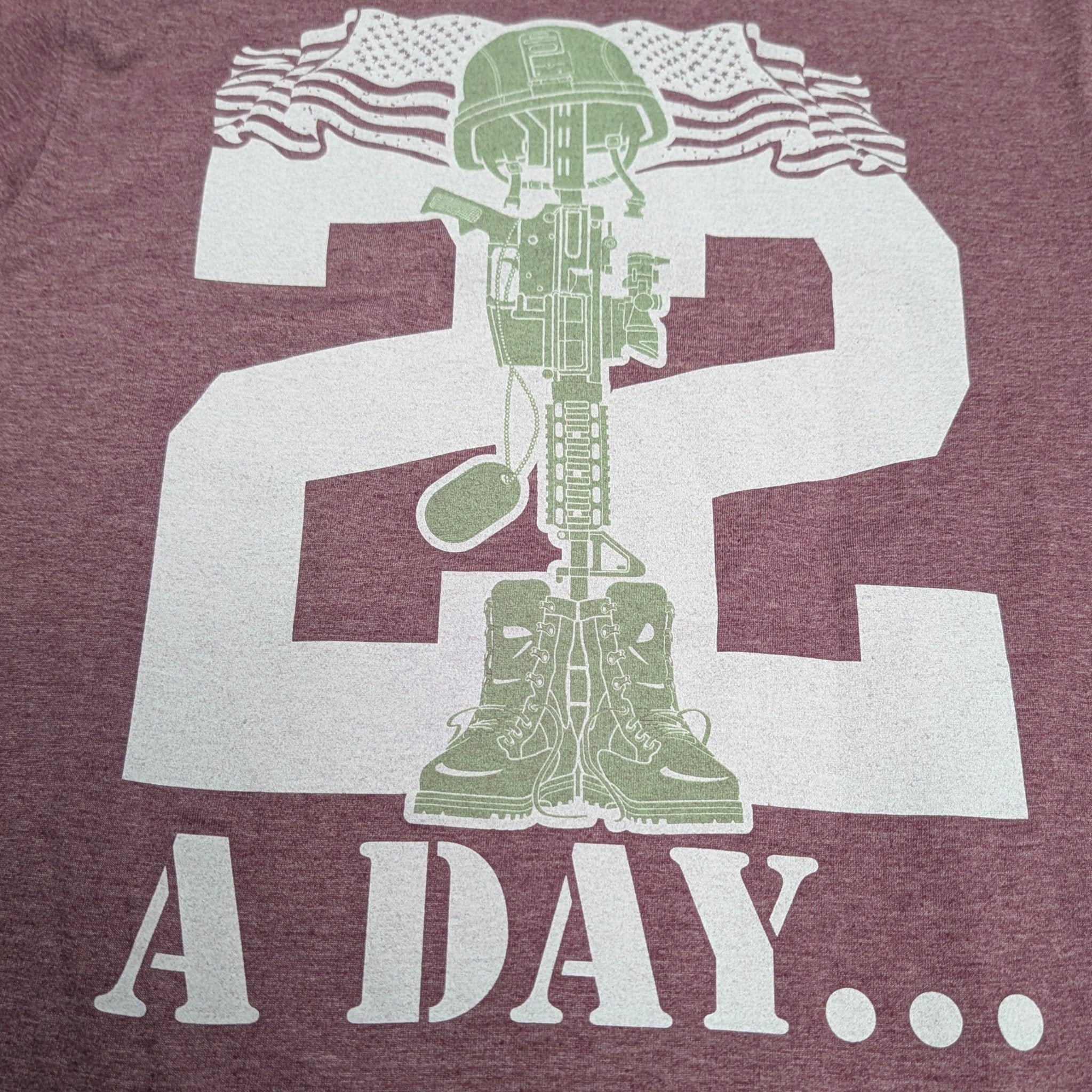 The "22 A Day" Premium Veteran Awareness Tee - Meridian EDC | Laserworks - Maroon t-shirt with white graphic design featuring a soldier and text on a plain background