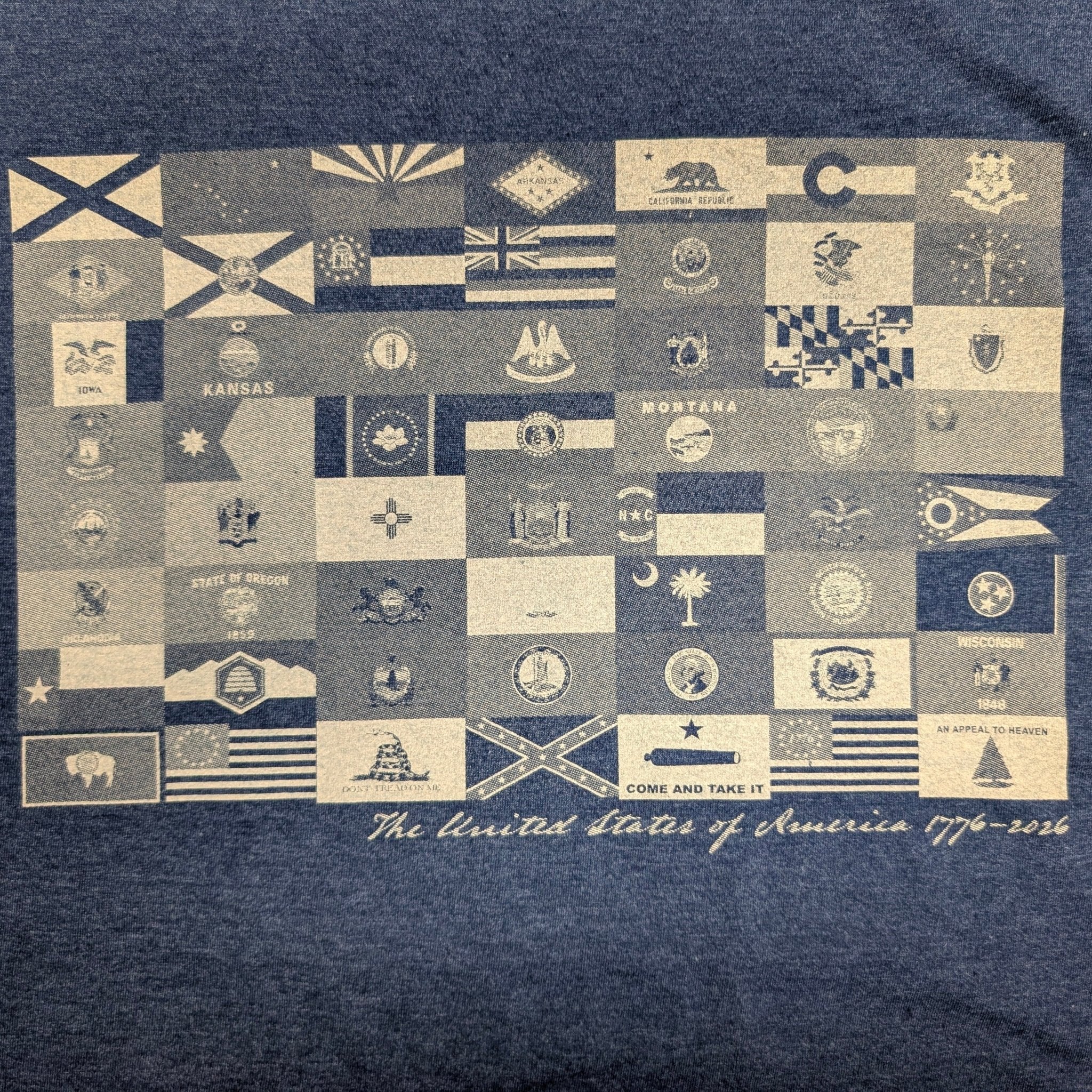The "250 Years of Liberty" Premium Graphic Tee - Meridian EDC | Laserworks - Navy blue t-shirt with a pattern of small flags and text on a dark background