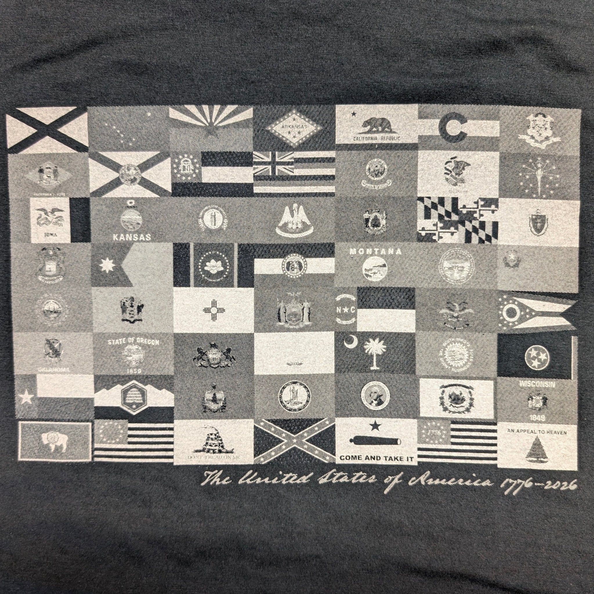 The "250 Years of Liberty" Premium Graphic Tee - Meridian EDC | Laserworks - Black t-shirt with a pattern of small flags and text on a dark background