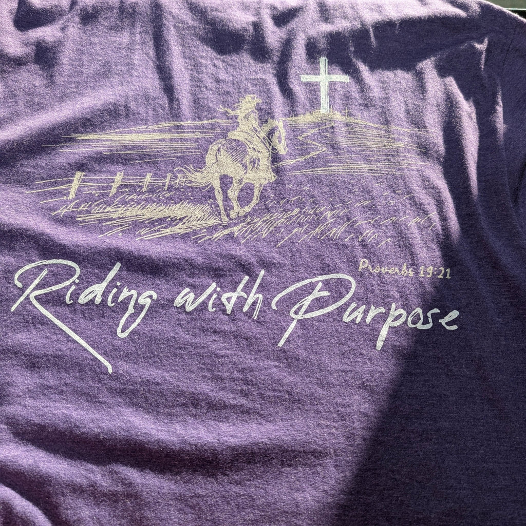 The "Day 41" Premium Graphic Tee - Meridian EDC | Laserworks - Purple t-shirt with a graphic of a horse and rider and the text 'Riding with Purpose'.