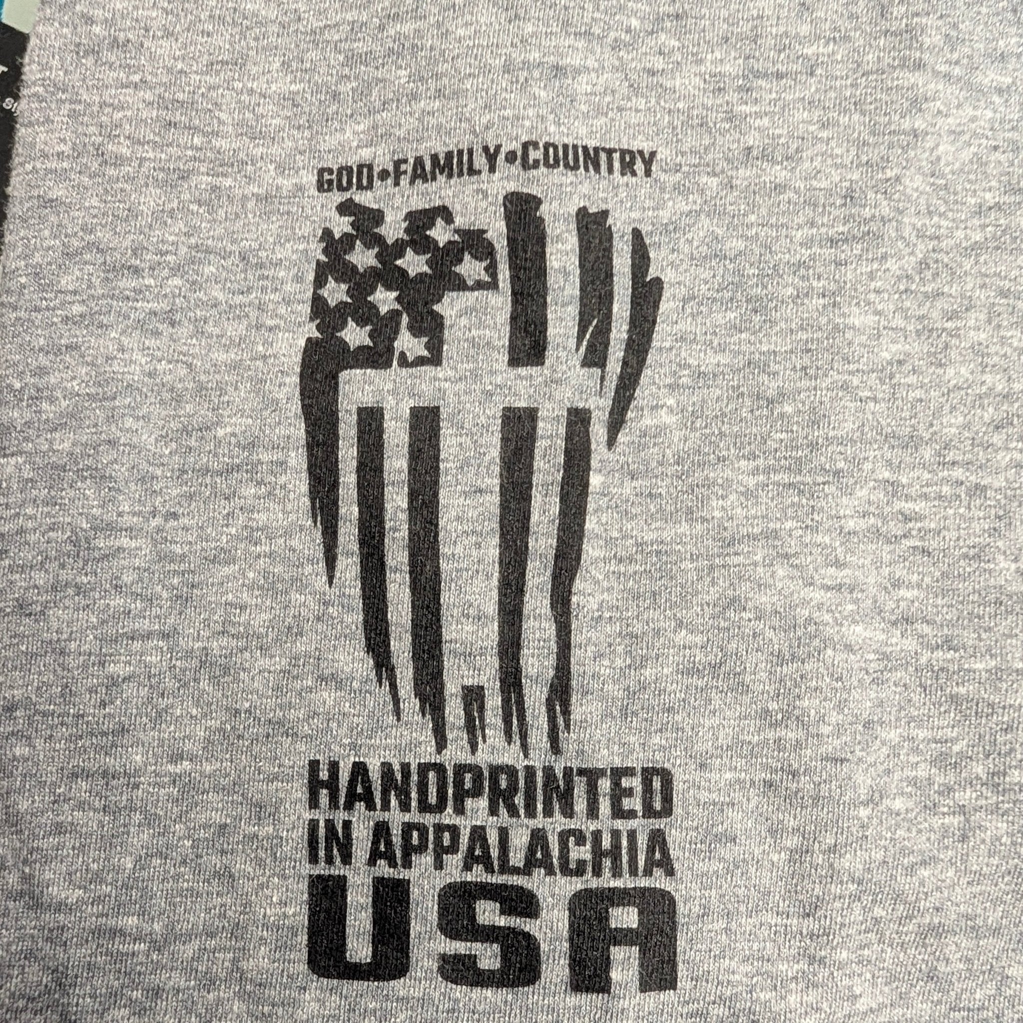 The "Faith & Fortitude" Premium Graphic Tee - Work Hard, Pray Hard - Meridian EDC | Laserworks - Gray fabric with black text and graphics, including 'Handprinted in Appalachia USA'.