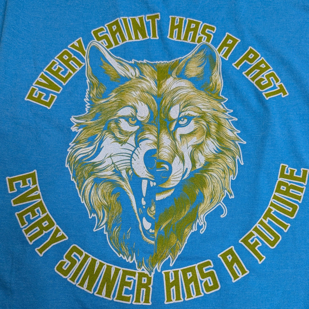 The "Iron & Grace" Premium Graphic Tee - Meridian EDC | Laserworks - Blue t-shirt with a wolf graphic and text on a blue background
