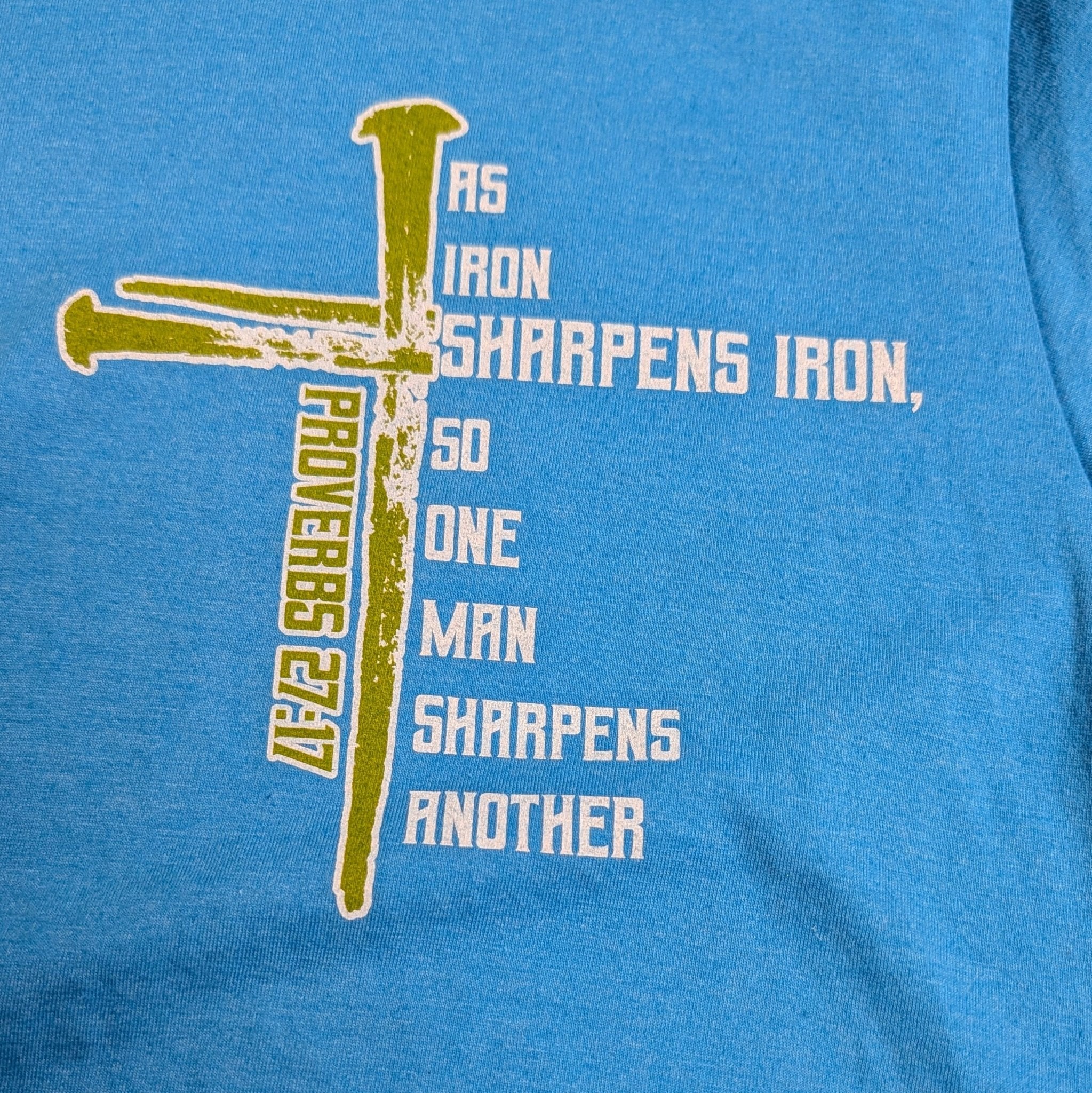 The "Iron & Grace" Premium Graphic Tee - Meridian EDC | Laserworks - Blue t-shirt with a graphic design and text on a blue background